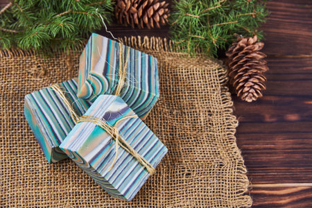 Bright striped handmade soap and various decor on the wooden countertop. Spa products.の写真素材