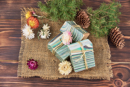 Bright striped handmade soap and various decor on the wooden countertop. Spa products.の写真素材
