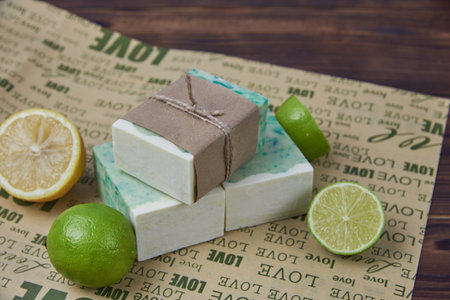 Fragrant handmade soap, lemon and lime, lie on the packaging paper with the inscription love. Healthy lifestyle, online sales.の写真素材