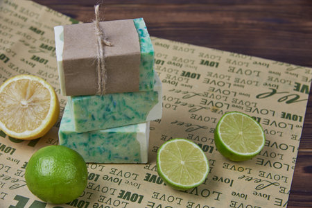 Fragrant handmade soap, lemon and lime, lie on the packaging paper with the inscription love. Healthy lifestyle, online sales.の写真素材
