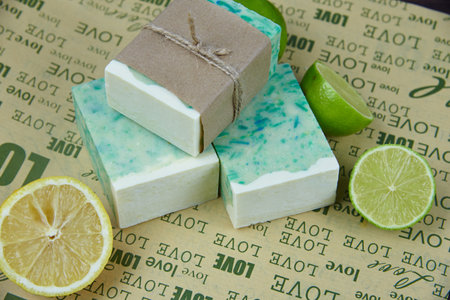 Fragrant handmade soap, lemon and lime, lie on the packaging paper with the inscription love. Healthy lifestyle, online sales.の写真素材