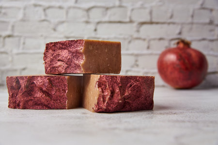 Bright handmade soap and garnet on a gray countertop against a brick wall. hobby to make a beautiful hand made natural soap from environmental products.の写真素材