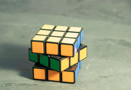 Russia, Moscow, January 2021. A bright puzzle on a gray background. The Rubiks Cube in disassembled form.のeditorial素材