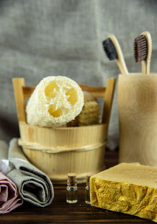Fragrant organic golden handmade soap and personal care items made of organic materials on a wooden countertop. The concept of a healthy lifestyle.の写真素材