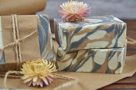 A few pieces of colorful, fragrant, hand-made organic soap on the packaging paper. Natural products, healthy lifestyle.の写真素材