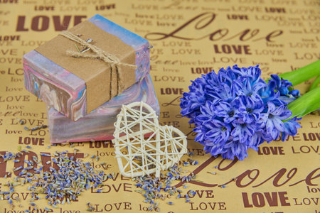 Fragrant multicolored handmade soap and hyacinth on wrapping paper with the inscription love.の写真素材