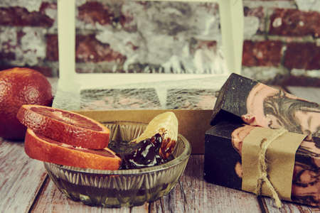 Natural handmade soap with chocolate and orange on a wooden countertop. Healthy lifestyle,...