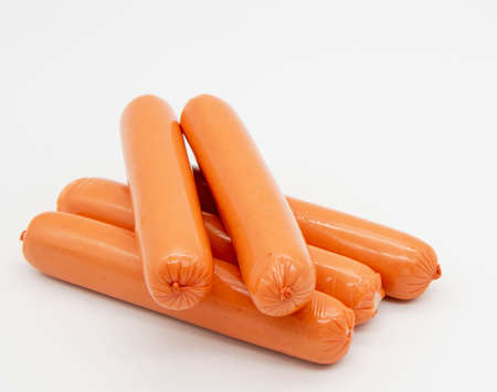 Fresh delicious sausages lie in a pile on a white background.の写真素材