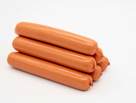 Fresh delicious sausages lie in a pile on a white background.の写真素材