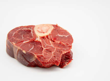 A piece of raw meat with a bone on a white background.の写真素材