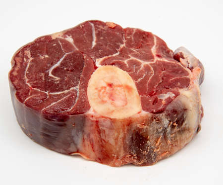 A piece of raw meat with a bone on a white background.の写真素材