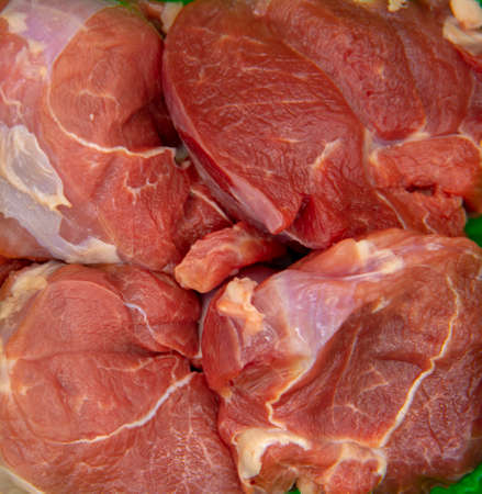 Full frame slices of raw meat as a backdrop.の写真素材