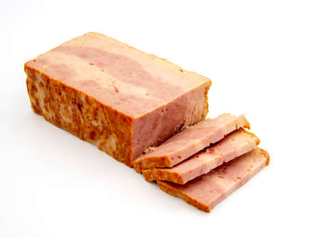 A delicious piece of smoked-boiled brisket with slices on a white background.の写真素材