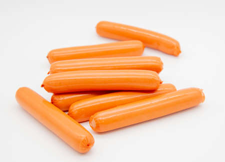 Fresh delicious sausages lie in a pile on a white background.の写真素材