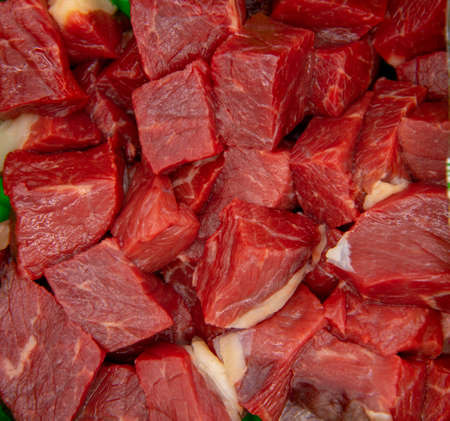 Full frame slices of raw meat as a backdrop.の写真素材