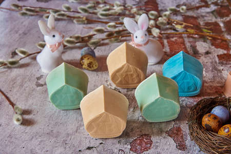 Delicate handmade Easter soap in the shape of domes, a variety of Easter decor on the textured...