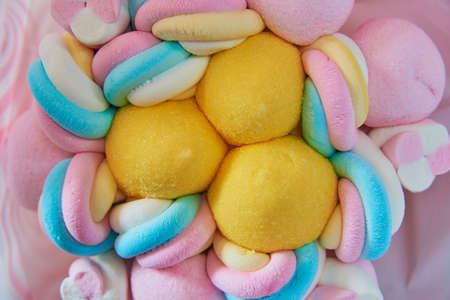 A bouquet of bright marshmallows in pink paper. Full frame multicolored marshmallow as a backdrop.の写真素材
