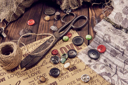 Sewing thread scissors buttons for seamstress on wooden background. Vintage Background.の写真素材