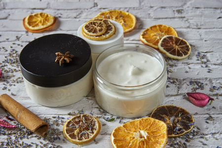Moisturizing cream organic with a lavender and orange dry on a brick table. Handmade, natural supplements, healthy lifestyle.の写真素材