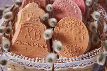 Delicate handmade Easter soap in a wicker basket and a variety of Easter decor.