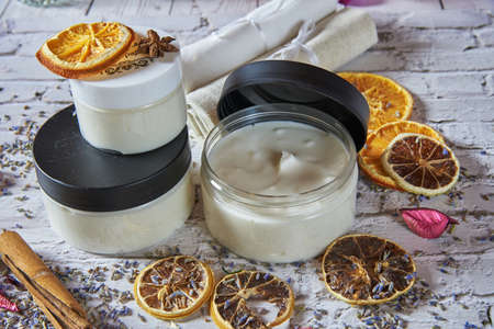 Moisturizing cream organic with a lavender and orange dry on a brick table. Handmade, natural supplements, healthy lifestyle.の写真素材