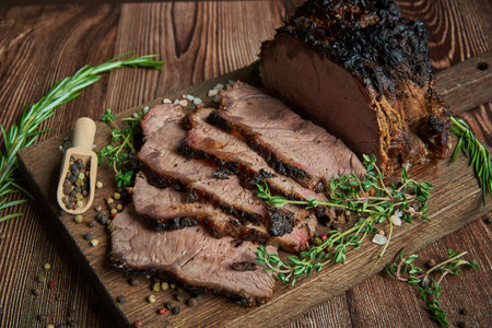 Roast beef on cutting board. Wooden background. Close up.の写真素材