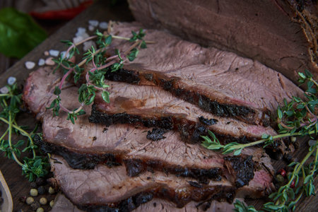 Roast beef on cutting board. Wooden background. Close up.の写真素材