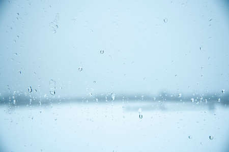 Abstract blurred background. Car glass with water drops from melting snow.の写真素材