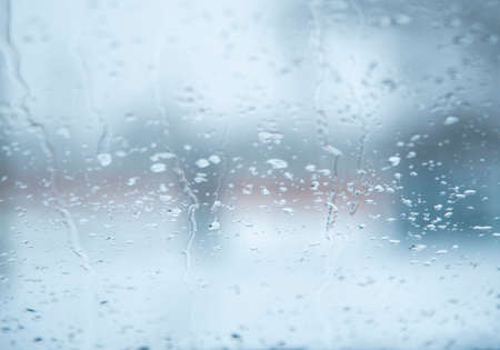 Abstract blurred background. Car glass with water drops from melting snow.の写真素材