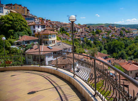 Houses with red tiled roofs , built on a mountain under a bright blue sky.Veliko Tarnovo in a beautiful summer day, Bulgariaの写真素材