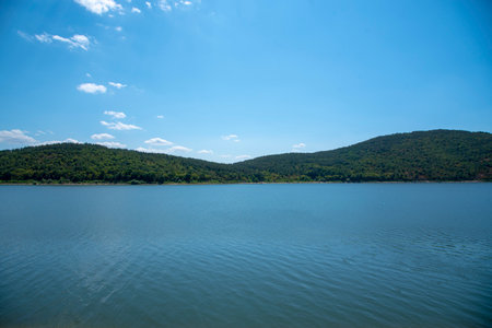 View of the blue lake against the background of the mountains on a clear sunny summer day.の写真素材