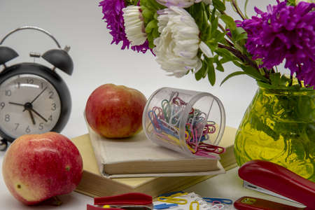 A composition of flowers in a vase, books and various educational accessories on a light background. Congratulations on the teacher's day.の写真素材