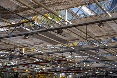 The ceiling in the greenhouse. Glass construction with frames and lamps.の写真素材