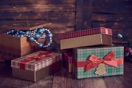 Christmas gifts and vintage casket with Christmas toys on a wooden background.の写真素材