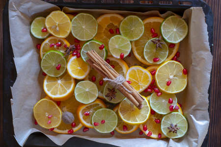 A full frame of citrus fruits, cut into slices and decorated with cinnamon. Food background. Focus on citrus fruits.の写真素材