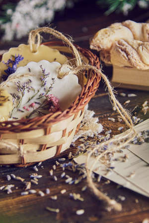 Fragrant handmade sachet made of soy wax with the addition of dried flowers in a wicker basket.の写真素材