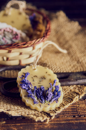 Fragrant handmade sachets made of beeswax, decorated with dried flowers in the interior.の写真素材