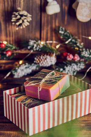 Bright multicolored handmade soap in a gift box on the background of a New Year's decor.の写真素材