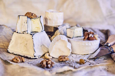 Various types of cheese with white mold on packaging paper. Home production, natural products.の写真素材