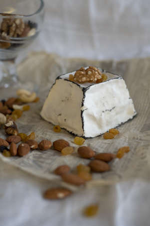 Various types of cheese with white mold on packaging paper. Home production, natural products.の写真素材