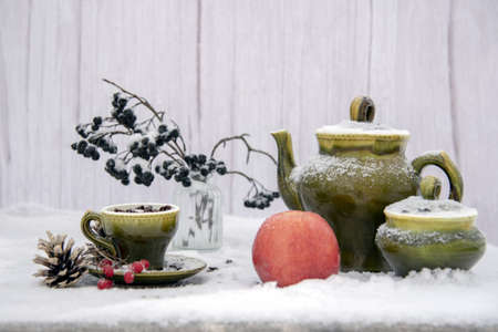 Winter still life with a green vintage set and berries of chokeberry.の写真素材