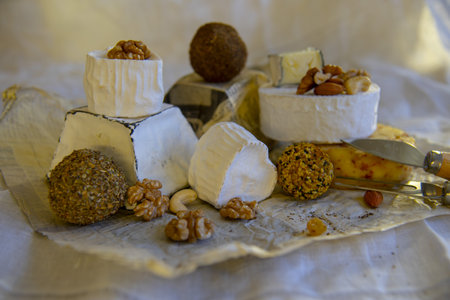 Various types of cheese with white mold on packaging paper. Home production, natural products.の写真素材
