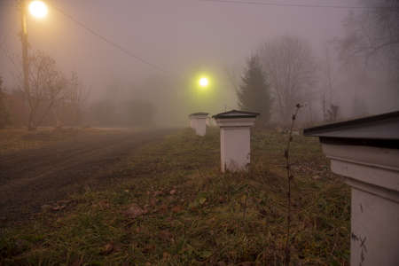 A village street in a thick fog. gloomy autumn landscape.の写真素材