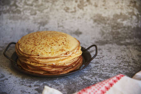 Delicious pancakes on a vintage metal platter on a concrete surface. food background.の写真素材