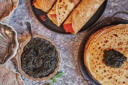 pancake week. Pancakes with red and black caviar. food background.