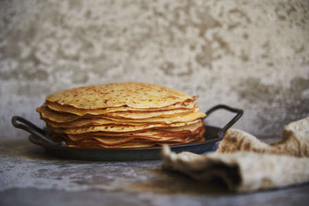 Delicious pancakes on a vintage metal platter on a concrete surface. food background.の写真素材