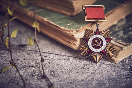 Russia, Moscow, February 2022. Victory Day May 9 holiday background composition, Soviet order , Second World war, books,birch branches. Copy space, postcard.のeditorial素材
