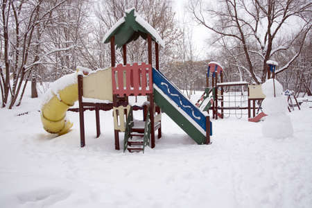 An empty playground in the snow in a public park.の写真素材