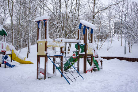 An empty playground in the snow in a public park.の写真素材