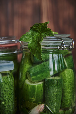Preservations, conservation. Salted, pickled cucumbers in a jar on an old wooden table.の写真素材